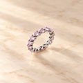 Blush Heart Eternity Ring on beige background